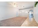 Spacious living room featuring tile floors, carpet, ample natural light, and a modern ceiling fan at 1632 Lansfield Ave, Deltona, FL 32738