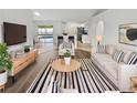Bright living room featuring a comfortable seating arrangement, stylish decor, and sliding door to a patio at 1730 Lochshyre Loop, Ocoee, FL 34761
