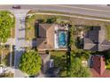 Aerial view of a home with a screened pool, manicured yard, and close proximity to nearby homes at 201 Twelve League Cir, Casselberry, FL 32707
