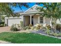 Lovely one story home with well maintained landscaping and an inviting covered front porch at 223 Silver Maple Rd, Groveland, FL 34736