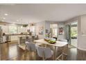 Open concept kitchen and dining area with wood floors and lots of natural light at 223 Silver Maple Rd, Groveland, FL 34736