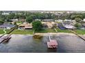 Waterfront home with a private dock, sandy beach, and lush green backyard at 2501 Trentwood Blvd, Belle Isle, FL 32812