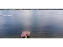 Scenic view of the serene lake with a private boathouse at 2501 Trentwood Blvd, Belle Isle, FL 32812