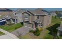 Stunning two-story house with a well-kept lawn and brick driveway at 2825 Muller Oak Loop, Ocoee, FL 34761