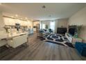 Open-concept living room with modern decor and hardwood floors at 2825 Muller Oak Loop, Ocoee, FL 34761