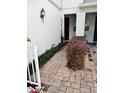 Paver walkway leads to the entrance of the home, with mature landscaping at 3181 Capri Isle Way, Orlando, FL 32835