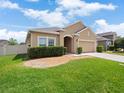 Well-kept single-Gathering home showcasing a green lawn, and a two-car garage at 3505 Rhapsody St, St Cloud, FL 34772