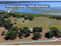 Aerial shot of a large, open parcel of land near Whaley's Landing, marked by green borders at 3650 Lake Tohopekaliga Rd, St Cloud, FL 34772