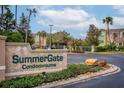 Welcoming SummerGate Condominiums sign with manicured landscaping and a glimpse of the community at 4897 Cypress Woods Dr # 6314, Orlando, FL 32811
