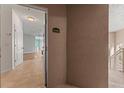 View of the entrance door, revealing a glimpse of the interior with tile flooring and neutral wall paint at 4897 Cypress Woods Dr # 6314, Orlando, FL 32811