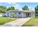 Street view of a single-story home with a carport and manicured lawn and walkway at 4908 Keith Pl, Orlando, FL 32808