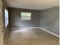 Bright living room featuring neutral carpet, fresh paint, and natural light from a window at 520 Ruffel St, Maitland, FL 32751