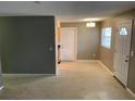 Cozy living room with access to kitchen, featuring neutral walls and access to front entrance at 520 Ruffel St, Maitland, FL 32751