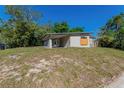 The exterior shot showing the side of a single-story house with a carport and tidy yard at 5201 Palisades Dr, Orlando, FL 32808