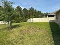 Spacious backyard featuring a well-maintained lawn and privacy fence at 5550 Bakewell Pl, St Cloud, FL 34771