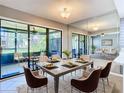 Dining room features a large table with mirrored wall reflecting open living space at 6021 Windhover Dr # F11, Orlando, FL 32819