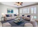 Stylish living room with large windows, shutters, and comfortable seating at 6021 Windhover Dr # F11, Orlando, FL 32819