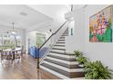 Bright entryway with wood floors, staircase, and views into the living and dining area at 6037 Caymus Loop, Windermere, FL 34786