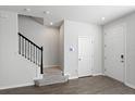 Bright entryway with stairs, a neutral color palette, and vinyl flooring, offering a modern, welcoming feel at 6165 Juneberry Way, Winter Garden, FL 34787