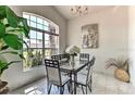 Bright dining room with large window, modern chandelier, and stylish table set at 730 Bloomingdale Dr, Davenport, FL 33897