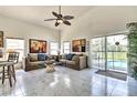 Inviting living area featuring neutral tones, marble floors and access to the pool area at 730 Bloomingdale Dr, Davenport, FL 33897