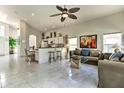 Open-concept living area with light-colored marble floors, fan, and abundant natural light at 730 Bloomingdale Dr, Davenport, FL 33897
