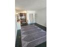 Open living space with tile floor, complemented by a large area rug at 7900 S Orange Blossom Trl # 2025, Orlando, FL 32809