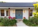 Inviting front entrance with stylish double doors, brick accents, and lush plants at 29540 Deerwood Farms Rd, Sorrento, FL 32776