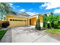 Inviting one-story home with a covered front entry, two-car garage, lush lawn and mature landscaping at 11718 Fitzgerald Butler Rd, Orlando, FL 32836