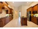 Modern kitchen with custom wood cabinets, granite countertops, and stainless steel appliances at 128 Hallstrom Ct, Debary, FL 32713