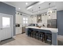 Open kitchen with a large island, pendant lighting, stainless steel appliances, and custom cabinetry at 129 S Park Ave # 129, Winter Garden, FL 34787