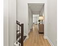Light-filled hallway with wood floors leads to other areas of the home at 16018 Volterra Pt, Bella Collina, FL 34756
