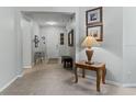 Welcoming foyer with neutral walls, tiled floor, and a decorative table creating an inviting entryway at 16810 Sunrise Vista Dr, Clermont, FL 34714