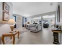Spacious living room with neutral tones, tile floors, and large windows for natural light creating an airy feel at 16810 Sunrise Vista Dr, Clermont, FL 34714
