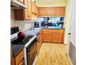 Functional kitchen with wood cabinets, laminate countertops, and essential appliances for meal preparation at 240 Windmeadows St # 240, Altamonte Springs, FL 32701