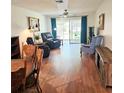 Spacious living room with hardwood floors and natural light streaming through the sliding glass doors at 240 Windmeadows St # 240, Altamonte Springs, FL 32701