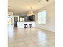 Bright open floorplan with tile flooring connecting living space to the modern kitchen at 2445 Cypress Trace Cir, Orlando, FL 32825