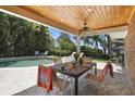 Covered patio with dining table, overlooking the pool and backyard at 2532 Waterview Pl, Windermere, FL 34786