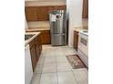 Functional kitchen features ample counter space and stainless-steel refrigerator at 3111 Wentworth Ln, Kissimmee, FL 34741