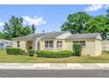 Charming single-story home featuring manicured shrubs and a concrete walkway at 320 Granada Dr, Winter Park, FL 32789