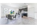Open concept kitchen with dark cabinets, granite counters, stainless appliances, and island with seating at 3389 Sw 126Th Lane Rd, Ocala, FL 34473