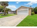 Well manicured lawn with an asphalt driveway leads to the two car garage at 357 Kantor Blvd, Casselberry, FL 32707