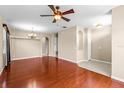 Open concept living room featuring hardwood floors, neutral walls, recessed lighting, and archways to other rooms at 4027 Sunrise Ridge Blvd, Groveland, FL 34736