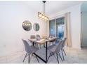 Cozy dining area with stylish lighting, table setting and sliding door access at 4220 Paragraph Dr, Kissimmee, FL 34746