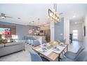 Open-concept living area featuring a modern kitchen, dining table and comfortable seating at 4220 Paragraph Dr, Kissimmee, FL 34746