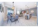 Open-concept living area seamlessly connects the dining, kitchen and living spaces at 4220 Paragraph Dr, Kissimmee, FL 34746