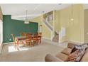 View of the bright dining room and staircase at 466 Drexel Ridge Cir, Ocoee, FL 34761