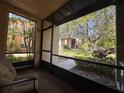 Relaxing screened patio with outdoor seating and a view of the landscaped grounds at 4800 S Semoran Blvd # 101, Orlando, FL 32822