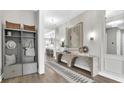 Chic foyer featuring light gray walls, an arched console table, light hardwood floors, and views of an open concept floorplan at 52 Overleaf Ln, Orlando, FL 32839