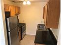 Efficient kitchen with stainless steel appliances, wooden cabinets, and practical countertops at 530 Ruffel St, Maitland, FL 32751